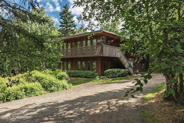11851 Nebesna Dr, Anchorage, AK 99507 - rear view of house featuring stairway, driveway, and a deck