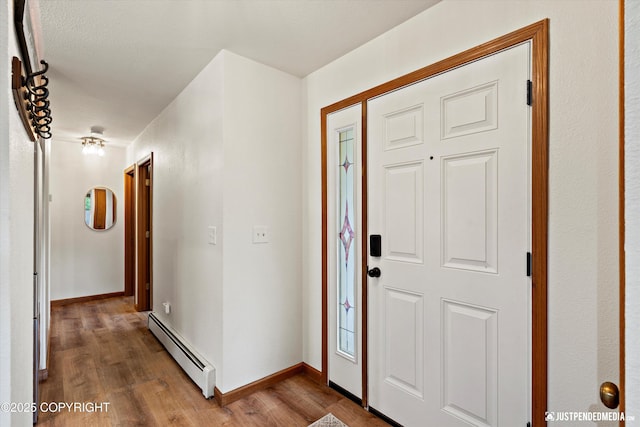 6922 Cutty Sark St, Anchorage, AK 99502 - foyer entrance with a baseboard heating unit and wood finished floors