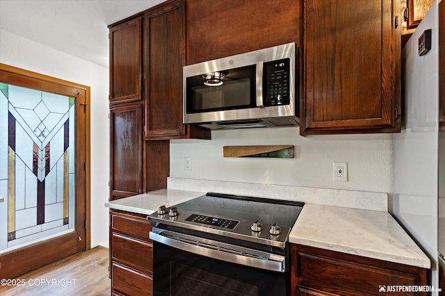 6922 Cutty Sark St, Anchorage, AK 99502 - kitchen featuring stainless steel appliances, dark brown cabinets, and light wood finished floors