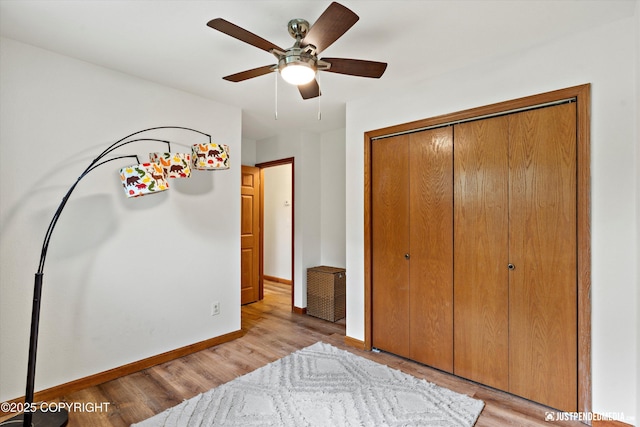 6922 Cutty Sark St, Anchorage, AK 99502 - bedroom with light wood-style flooring, a closet, and a ceiling fan