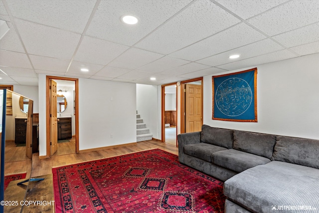 6922 Cutty Sark St, Anchorage, AK 99502 - living area featuring wood finished floors, a paneled ceiling, and stairs