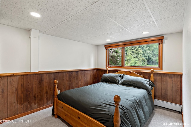 6922 Cutty Sark St, Anchorage, AK 99502 - bedroom with a baseboard radiator, carpet flooring, a wainscoted wall, wood walls, and recessed lighting
