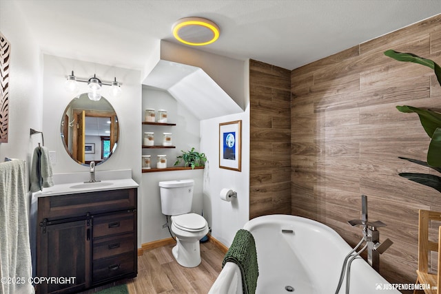 6922 Cutty Sark St, Anchorage, AK 99502 - bathroom featuring vanity, a tub to relax in, and wood finished floors