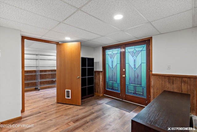 6922 Cutty Sark St, Anchorage, AK 99502 - foyer entrance featuring a wainscoted wall, wood finished floors, a drop ceiling, and wood walls