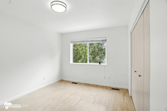 9380 Sea Parrot Cir, Anchorage, AK 99515 - unfurnished bedroom with a closet and light wood finished floors