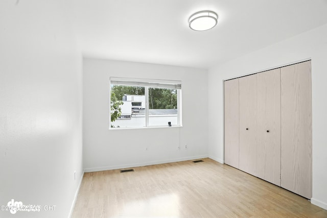 9380 Sea Parrot Cir, Anchorage, AK 99515 - unfurnished bedroom featuring wood finished floors and a closet