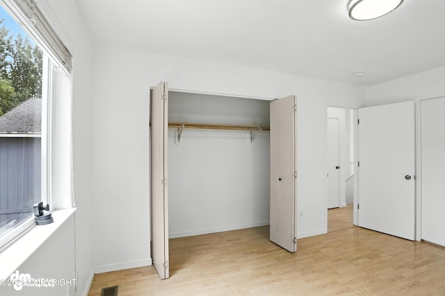 9380 Sea Parrot Cir, Anchorage, AK 99515 - unfurnished bedroom featuring light wood-style floors and baseboards