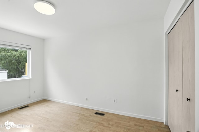9380 Sea Parrot Cir, Anchorage, AK 99515 - unfurnished bedroom with light wood-style floors and a closet