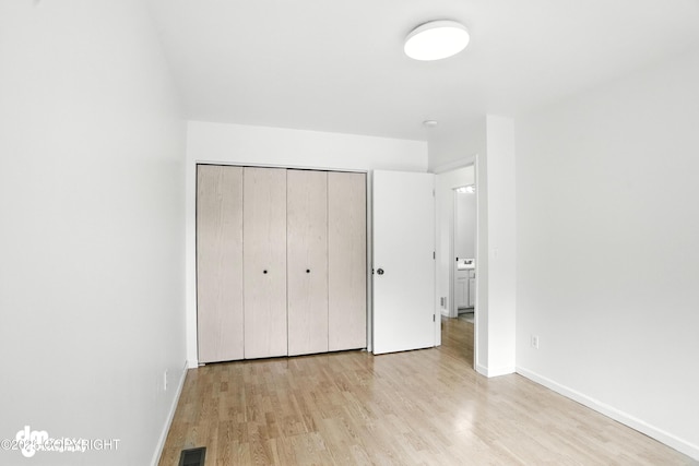 9380 Sea Parrot Cir, Anchorage, AK 99515 - unfurnished bedroom with wood finished floors and a closet