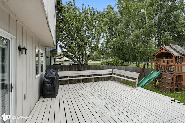 9380 Sea Parrot Cir, Anchorage, AK 99515 - wooden terrace with a playground, a fenced backyard, and area for grilling