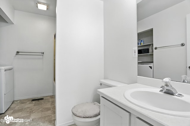 9380 Sea Parrot Cir, Anchorage, AK 99515 - bathroom featuring washer / dryer, vanity, and bathing tub / shower combination