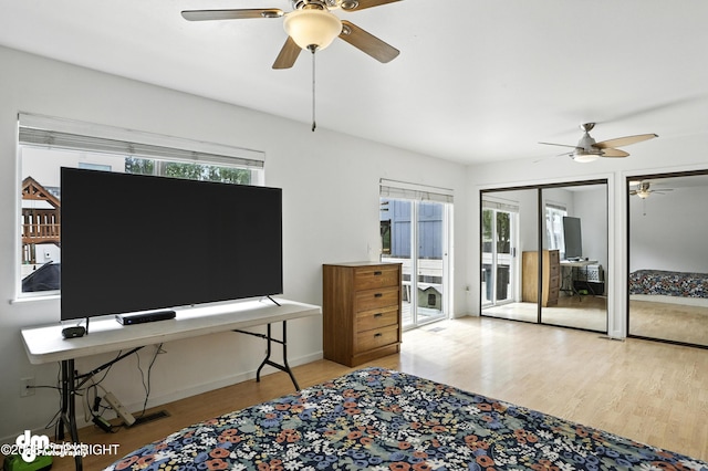 9380 Sea Parrot Cir, Anchorage, AK 99515 - bedroom featuring wood finished floors, multiple closets, and a ceiling fan