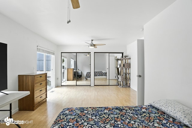 9380 Sea Parrot Cir, Anchorage, AK 99515 - bedroom featuring light wood finished floors, multiple closets, and ceiling fan
