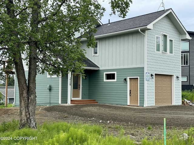 3715 Tajen Ln, Homer, AK 99603 - back of house with dirt driveway, a shingled roof, and a garage