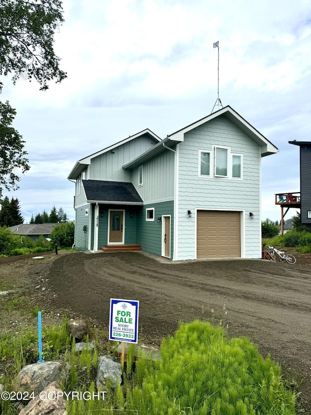 3715 Tajen Ln, Homer, AK 99603 - view of front of home featuring board and batten siding, a garage, and driveway