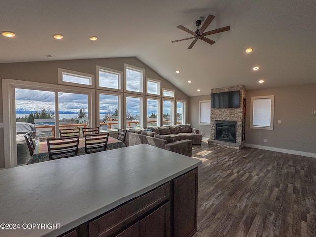 3715 Tajen Ln, Homer, AK 99603 - kitchen with vaulted ceiling, dark wood finished floors, ceiling fan, a fireplace, and recessed lighting
