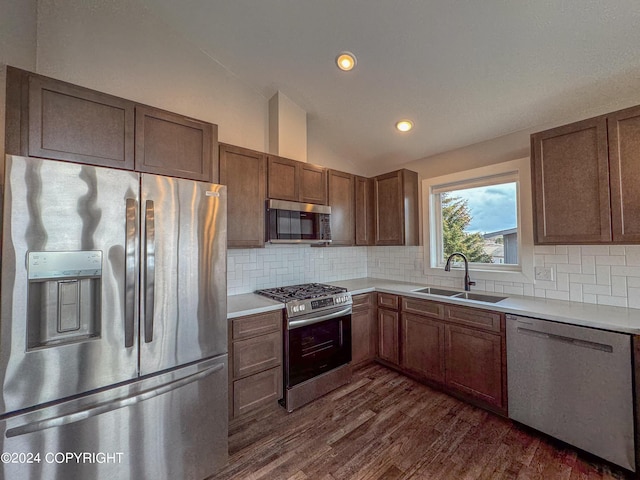3715 Tajen Ln, Homer, AK 99603 - kitchen with stainless steel appliances, dark wood-style flooring, lofted ceiling, light countertops, and tasteful backsplash