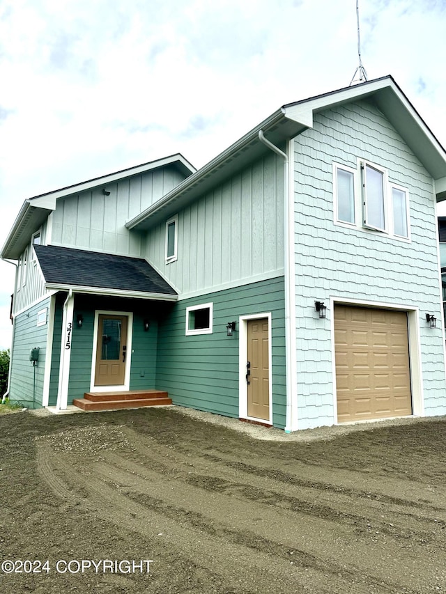 3715 Tajen Ln, Homer, AK 99603 - view of front of home with board and batten siding, driveway, and a garage