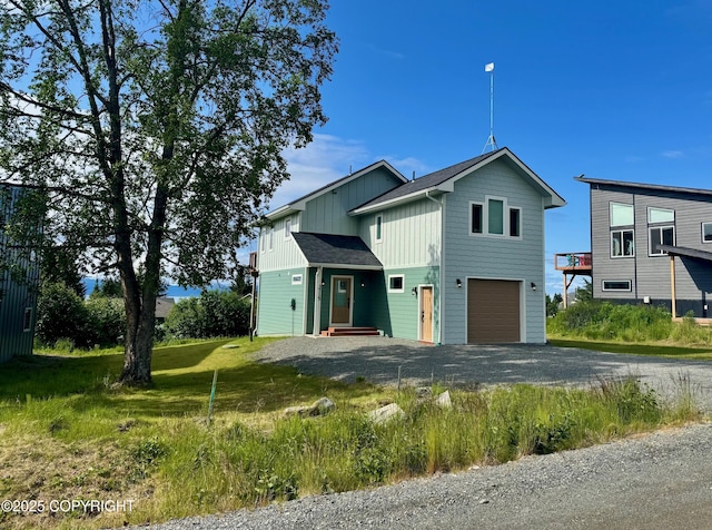 3715 Tajen Ln, Homer, AK 99603 - view of front facade with board and batten siding, driveway, and a garage