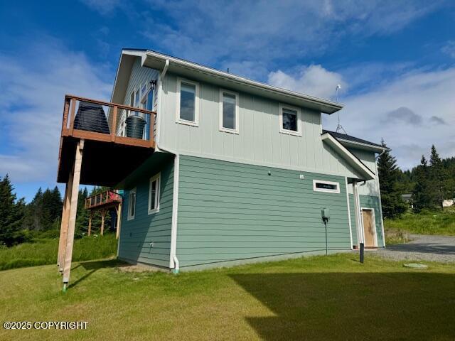 3715 Tajen Ln, Homer, AK 99603 - view of side of home featuring a lawn and board and batten siding