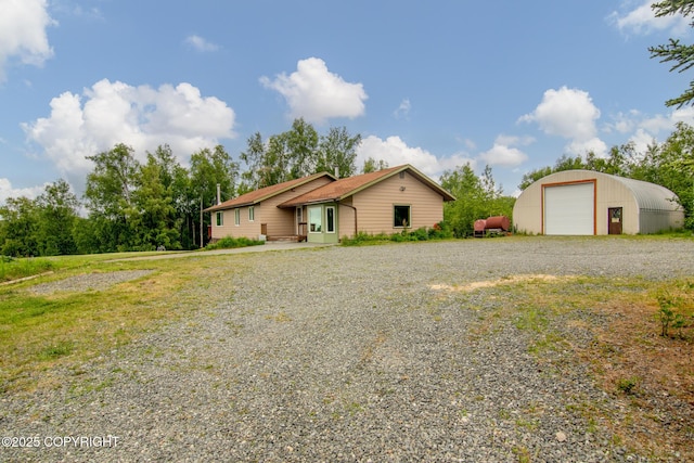 40800 Lopez Ave, Soldotna, AK 99669 - view of front of home featuring a detached garage, an outdoor structure, and gravel driveway