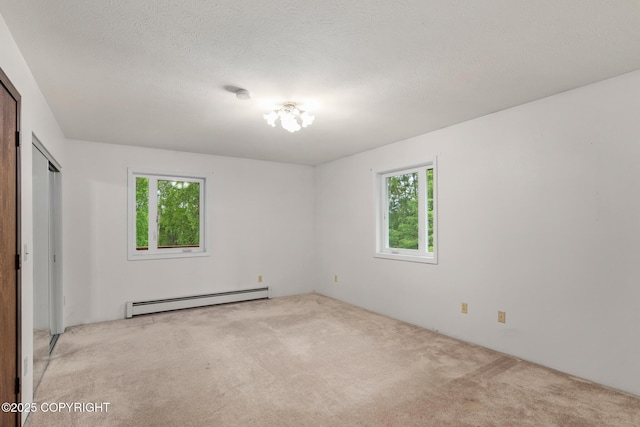 40800 Lopez Ave, Soldotna, AK 99669 - unfurnished bedroom with a baseboard heating unit and light carpet