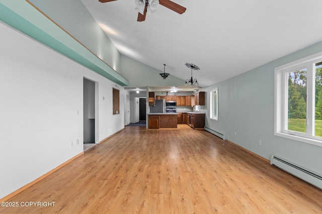 40800 Lopez Ave, Soldotna, AK 99669 - unfurnished living room with baseboard heating, a ceiling fan, lofted ceiling, and light wood-style floors