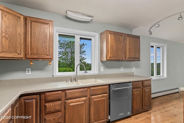 40800 Lopez Ave, Soldotna, AK 99669 - kitchen featuring stainless steel dishwasher, baseboard heating, light wood-type flooring, and light countertops