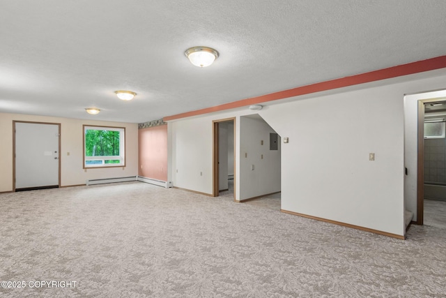 40800 Lopez Ave, Soldotna, AK 99669 - spare room featuring a baseboard radiator, light colored carpet, and a textured ceiling
