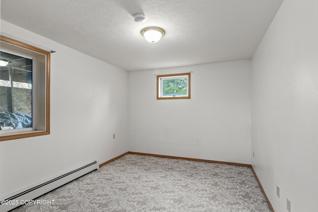 40800 Lopez Ave, Soldotna, AK 99669 - spare room featuring a baseboard heating unit, carpet flooring, a smoke detector, and a textured ceiling