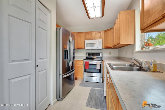 11929 W Wasey Cir, Houston, AK 99623 - kitchen featuring appliances with stainless steel finishes, light countertops, light flooring, and light brown cabinetry