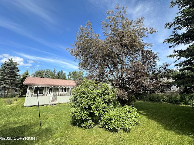 108 S Leibrock St, Soldotna, AK 99669 - view of front of house with a front yard and a metal roof