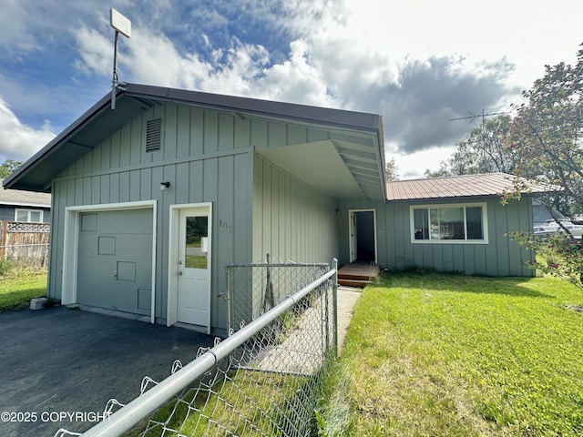 108 S Leibrock St, Soldotna, AK 99669 - view of front of house with board and batten siding, driveway, and a metal roof