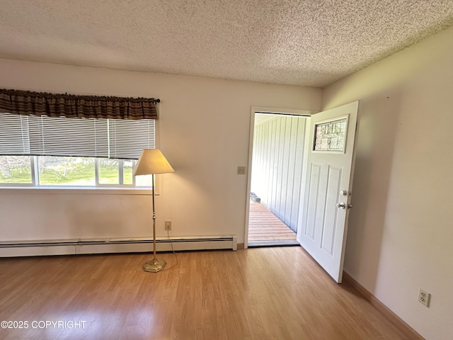 108 S Leibrock St, Soldotna, AK 99669 - foyer entrance with a baseboard heating unit, wood finished floors, and a textured ceiling