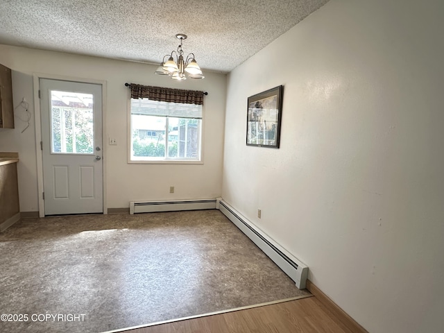 108 S Leibrock St, Soldotna, AK 99669 - unfurnished dining area featuring baseboard heating, a chandelier, a textured ceiling, and wood finished floors