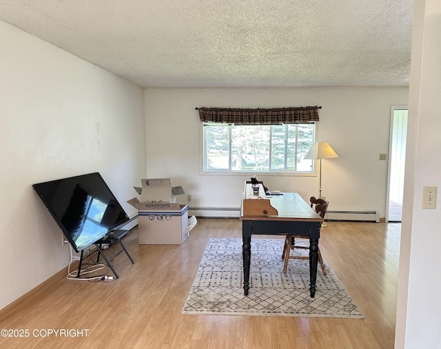 108 S Leibrock St, Soldotna, AK 99669 - office with a baseboard heating unit, wood finished floors, and a textured ceiling