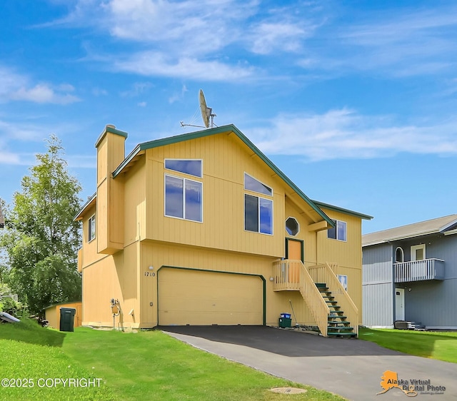 1710 Rierie Dr, Anchorage, AK 99507 - view of front of house with an attached garage, a chimney, stairs, driveway, and a front lawn
