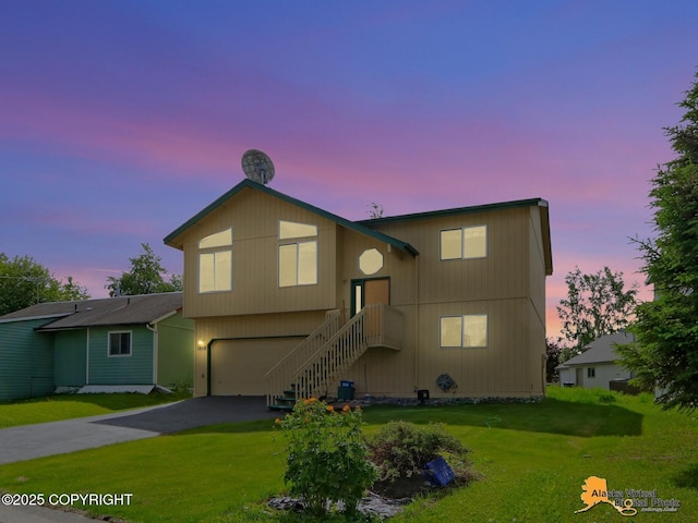 1710 Rierie Dr, Anchorage, AK 99507 - view of front of home featuring driveway, an attached garage, and a yard