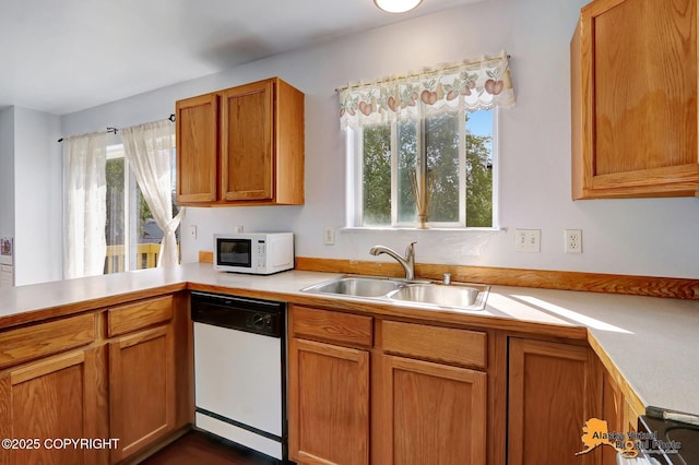1710 Rierie Dr, Anchorage, AK 99507 - kitchen featuring white appliances, light countertops, brown cabinets, and a peninsula