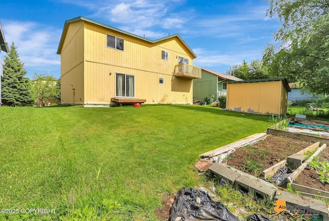 1710 Rierie Dr, Anchorage, AK 99507 - back of house featuring a vegetable garden and a lawn
