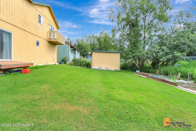 1710 Rierie Dr, Anchorage, AK 99507 - view of green lawn with a shed and a balcony