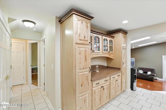 1801 Rebel Ridge Dr, Anchorage, AK 99504 - kitchen with light tile patterned floors, glass insert cabinets, light brown cabinets, recessed lighting, and stone countertops