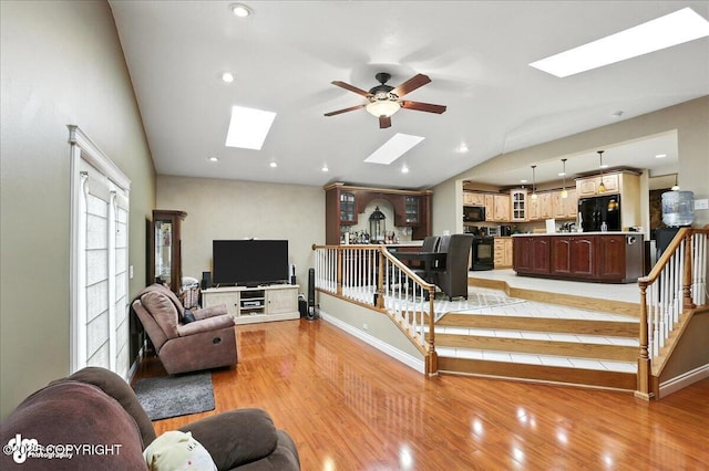 1801 Rebel Ridge Dr, Anchorage, AK 99504 - living area with a skylight, lofted ceiling, a ceiling fan, light wood-type flooring, and recessed lighting