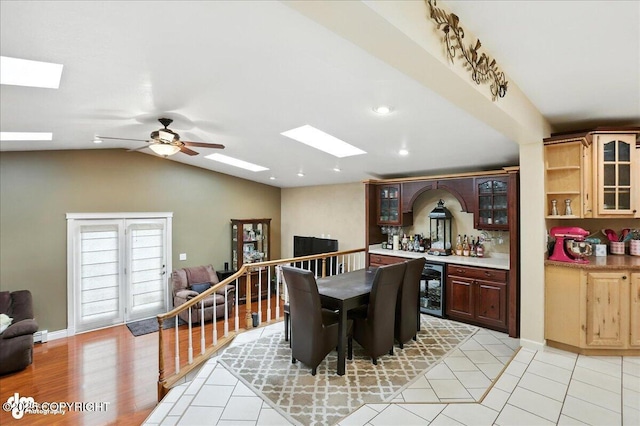 1801 Rebel Ridge Dr, Anchorage, AK 99504 - dining room with beverage cooler, a skylight, bar area, lofted ceiling, and ceiling fan