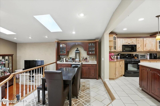 1801 Rebel Ridge Dr, Anchorage, AK 99504 - kitchen featuring black appliances, a skylight, glass insert cabinets, recessed lighting, and light countertops