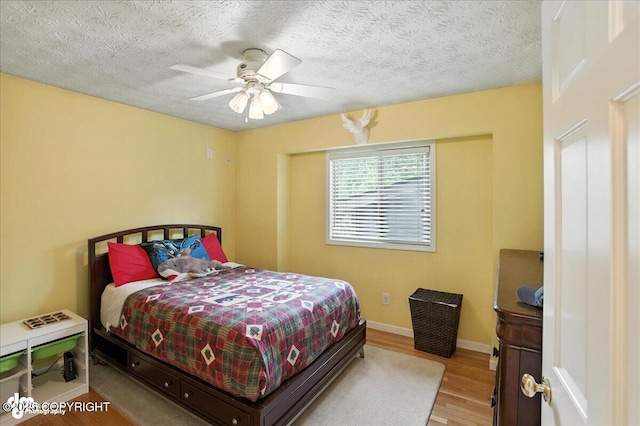 1801 Rebel Ridge Dr, Anchorage, AK 99504 - bedroom with wood finished floors, a ceiling fan, and a textured ceiling
