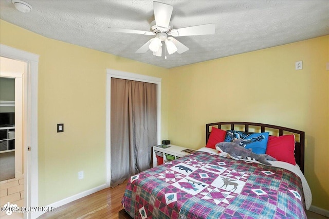 1801 Rebel Ridge Dr, Anchorage, AK 99504 - bedroom with wood finished floors, a closet, a ceiling fan, and a textured ceiling