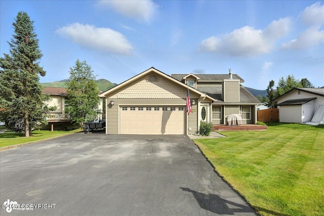 1801 Rebel Ridge Dr, Anchorage, AK 99504 - view of front of home with a garage, asphalt driveway, a front lawn, and a shed