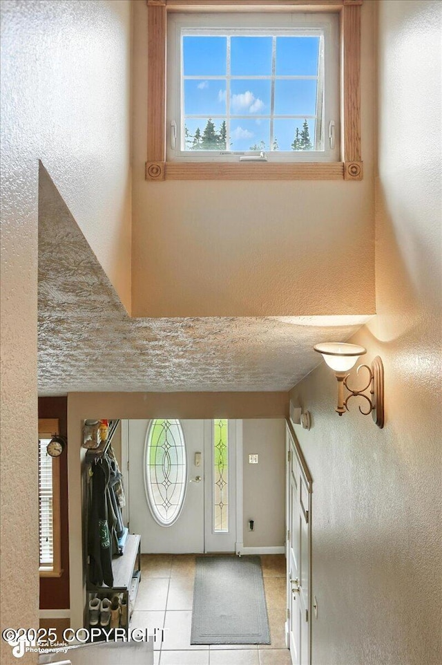 1801 Rebel Ridge Dr, Anchorage, AK 99504 - entryway featuring light tile patterned floors and a textured wall