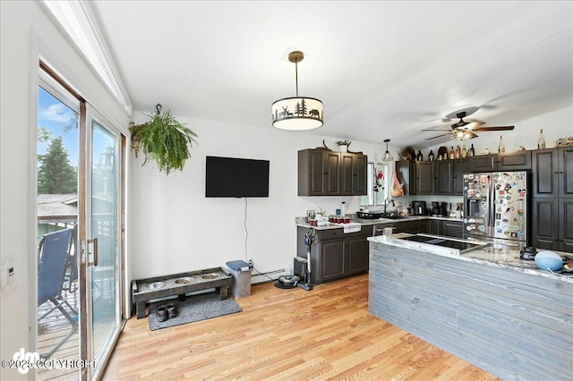 10845 Anvik Cir, Eagle River, AK 99577 - kitchen featuring stainless steel fridge, light countertops, ceiling fan, light wood-type flooring, and pendant lighting
